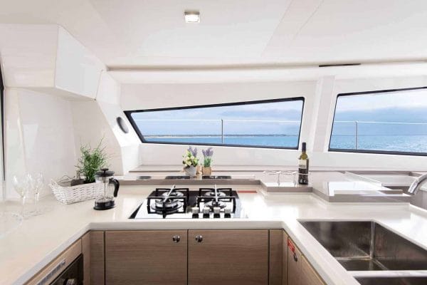 The galley of the Bali 5.4 with elegant design on everything from the windows, sink and stove, to the practical built-in bottle holders