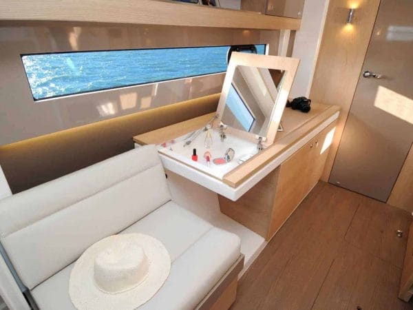 An open makeup cabinet and a hat on the sofa next to it in the beautiful cabin of the Bali 4.1