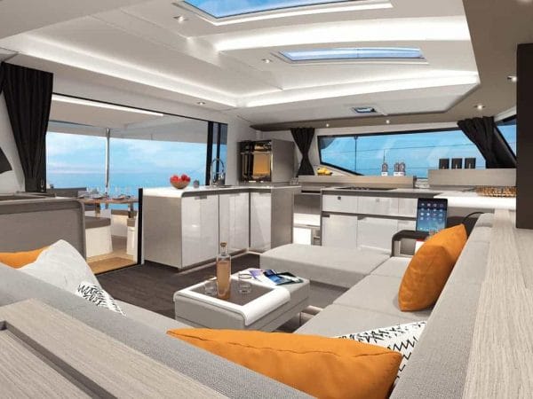 The gorgeous saloon of the Fountaine Pajot New 45 with a great, big sofa in it with modern design with orange details