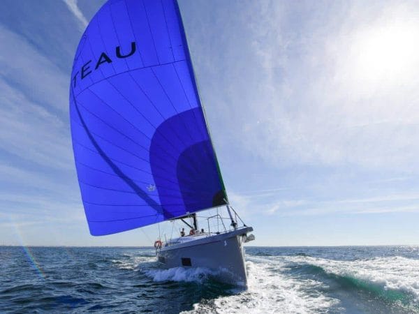 the elegant Beneteau Oceanis 46.1 sailing with wind in its sail towards the camera a sunny day