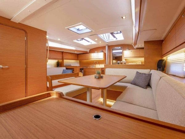 Overview of the beautiful and wooden interior of the Dufour GL 430 with saloon and galley