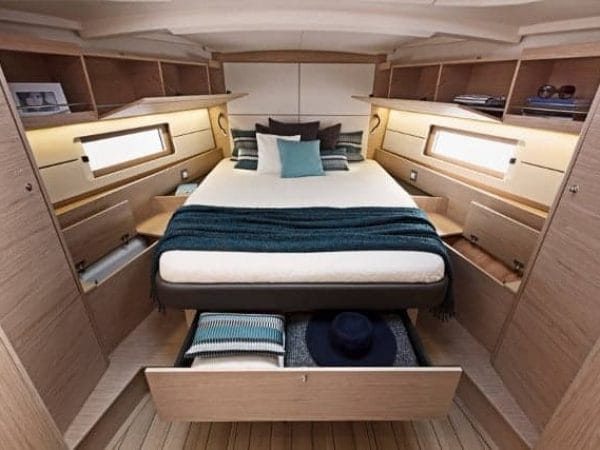 A comfortable and cozy cabin with a nice bed of the Beneteau Oceanis 46.1 with several storage options
